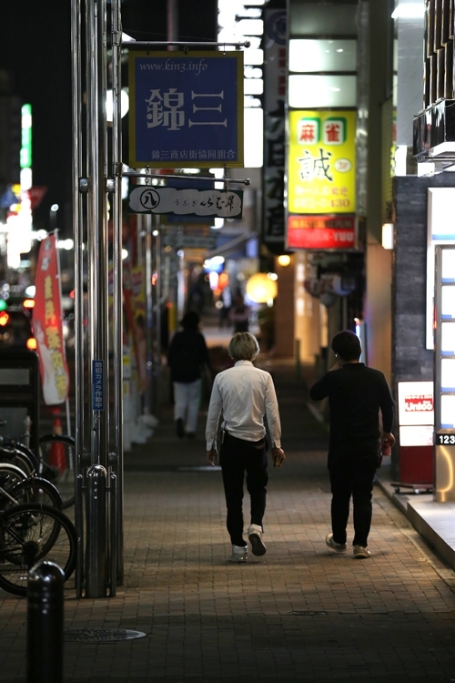 名古屋駅西口界隈 中村区 歓楽街 椿神社前交差点から名古屋駅の高層ビル群を望むの写真素材